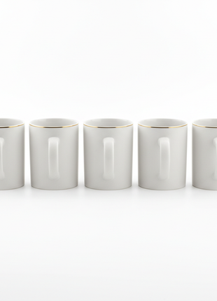 Set of 6 white ceramic mugs with gold rim arranged in a row