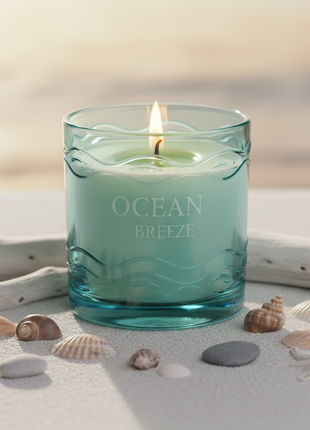Ocean Breeze scented candle in blue glass jar with seashells