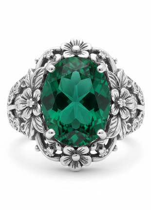 Women's vintage emerald cocktail ring in sterling silver with floral setting