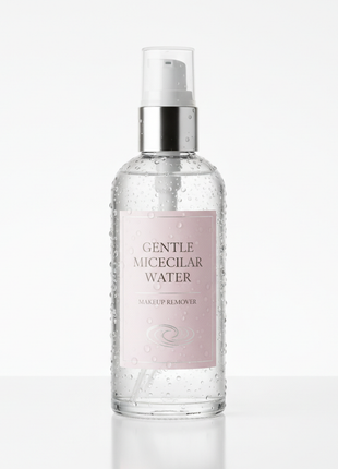 Clear glass pump bottle of gentle micellar makeup remover on white background