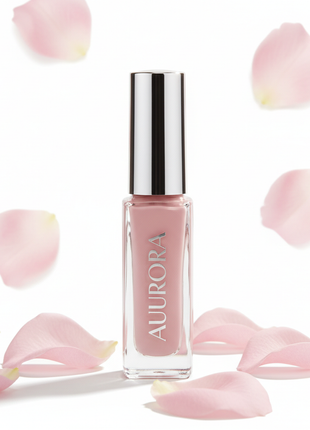 Elegant blush pink nail polish bottle with soft pink flower petals on white background